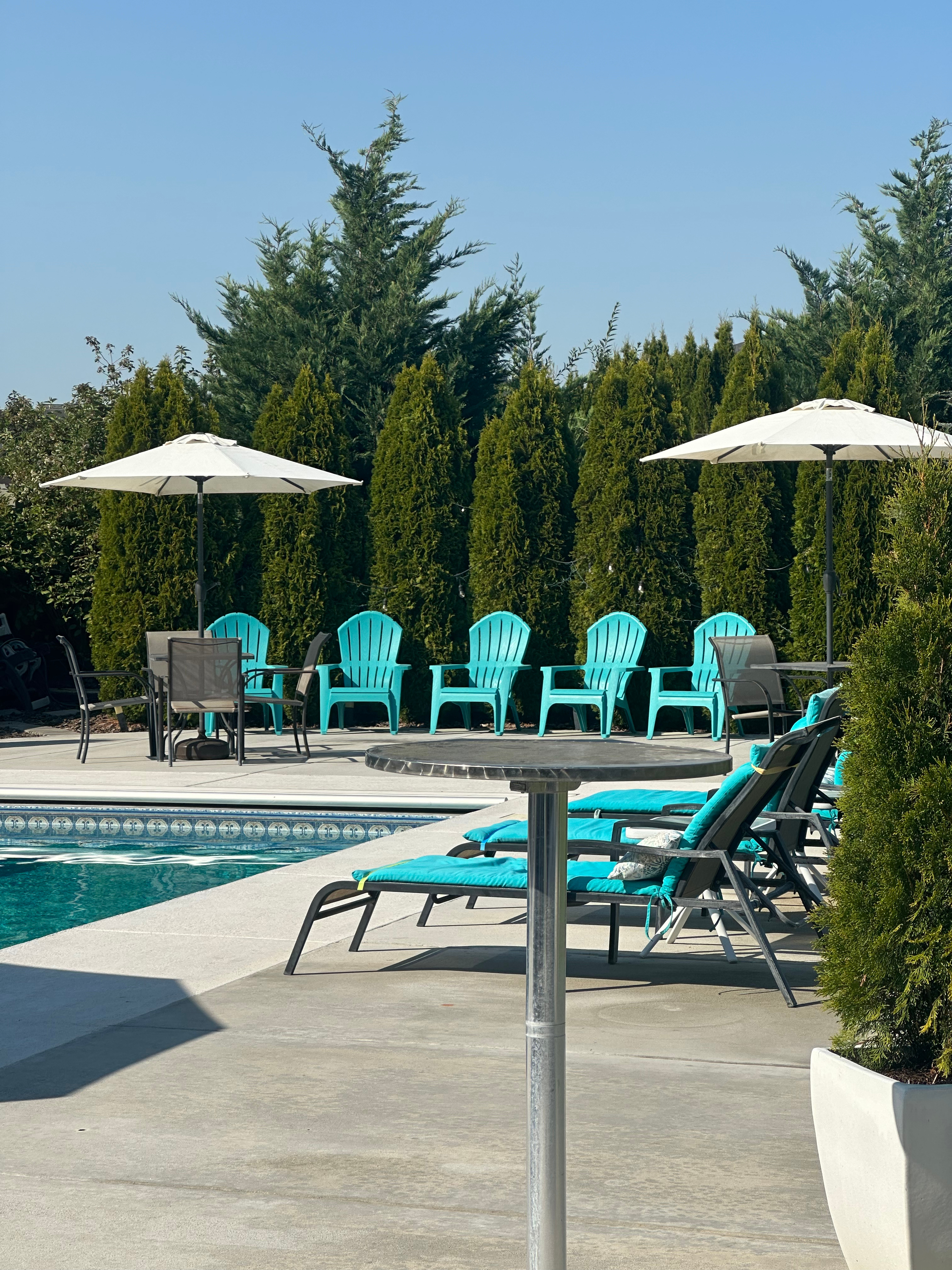 Turquoise loungers and umbrellas by the pool