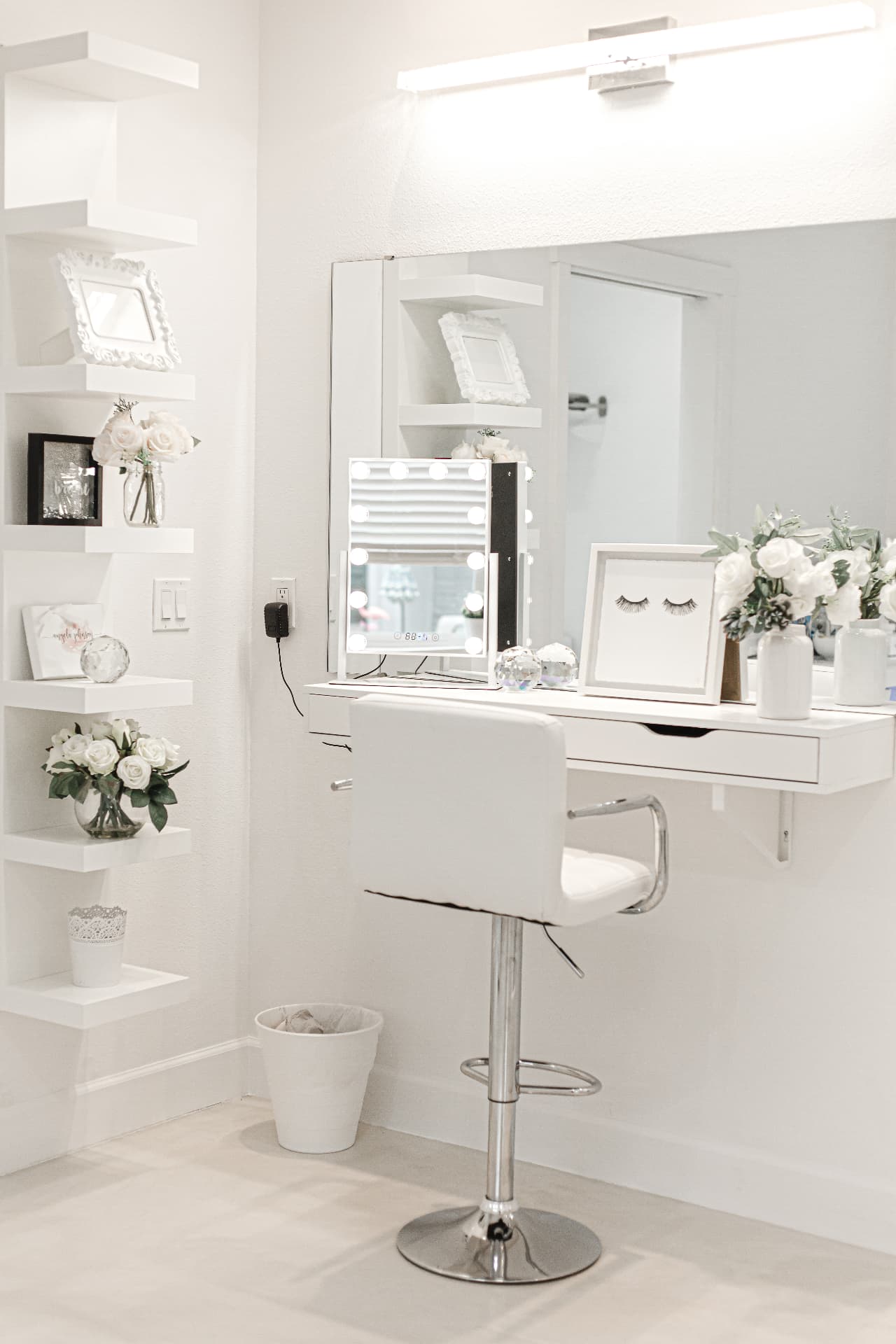 Hollywood vanity with lighted mirror and floral styling at Glam Studios
