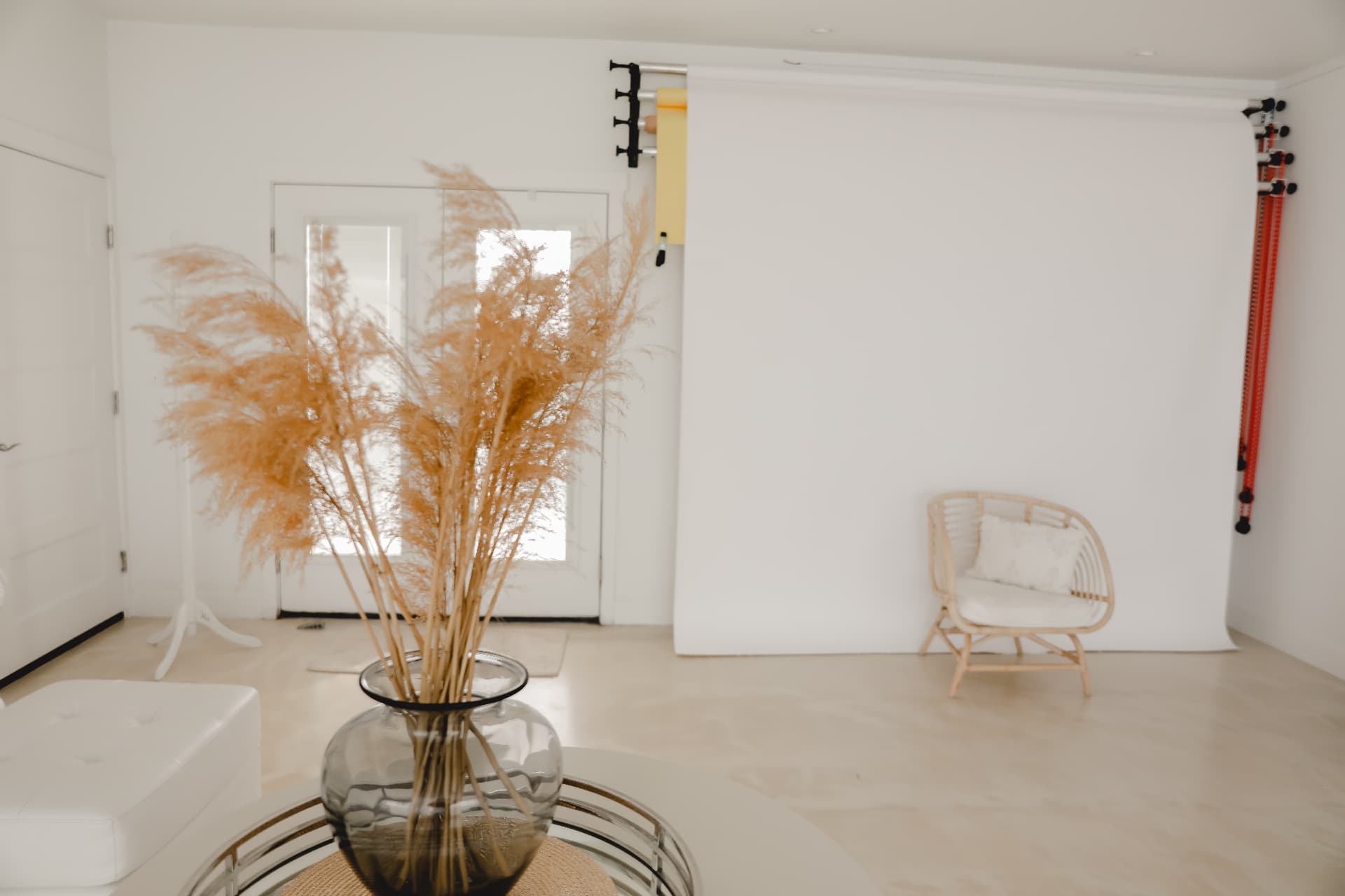 Open shoot bay with white sweep, rattan chair and pampas at Glam Studios