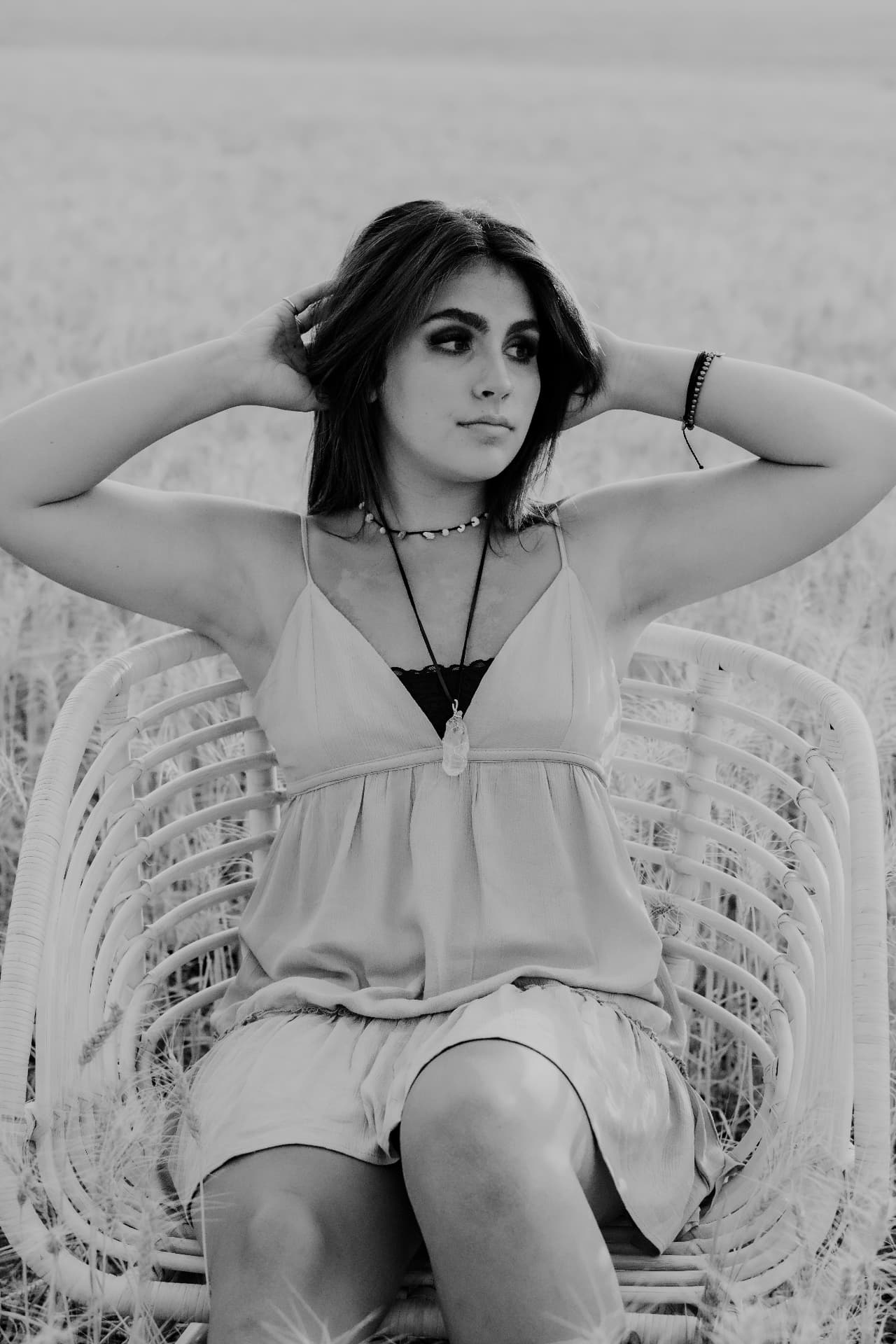Black and white portrait of a senior in a rattan chair