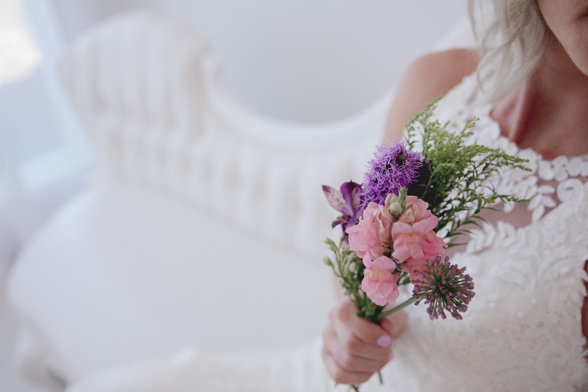 Wedding bouquet with pink and lilac florals in soft light