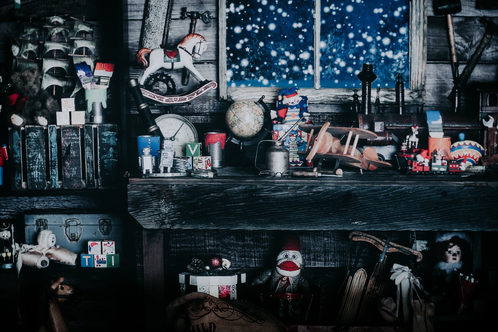 Santa's workshop shelves filled with vintage toys beside a snowy window